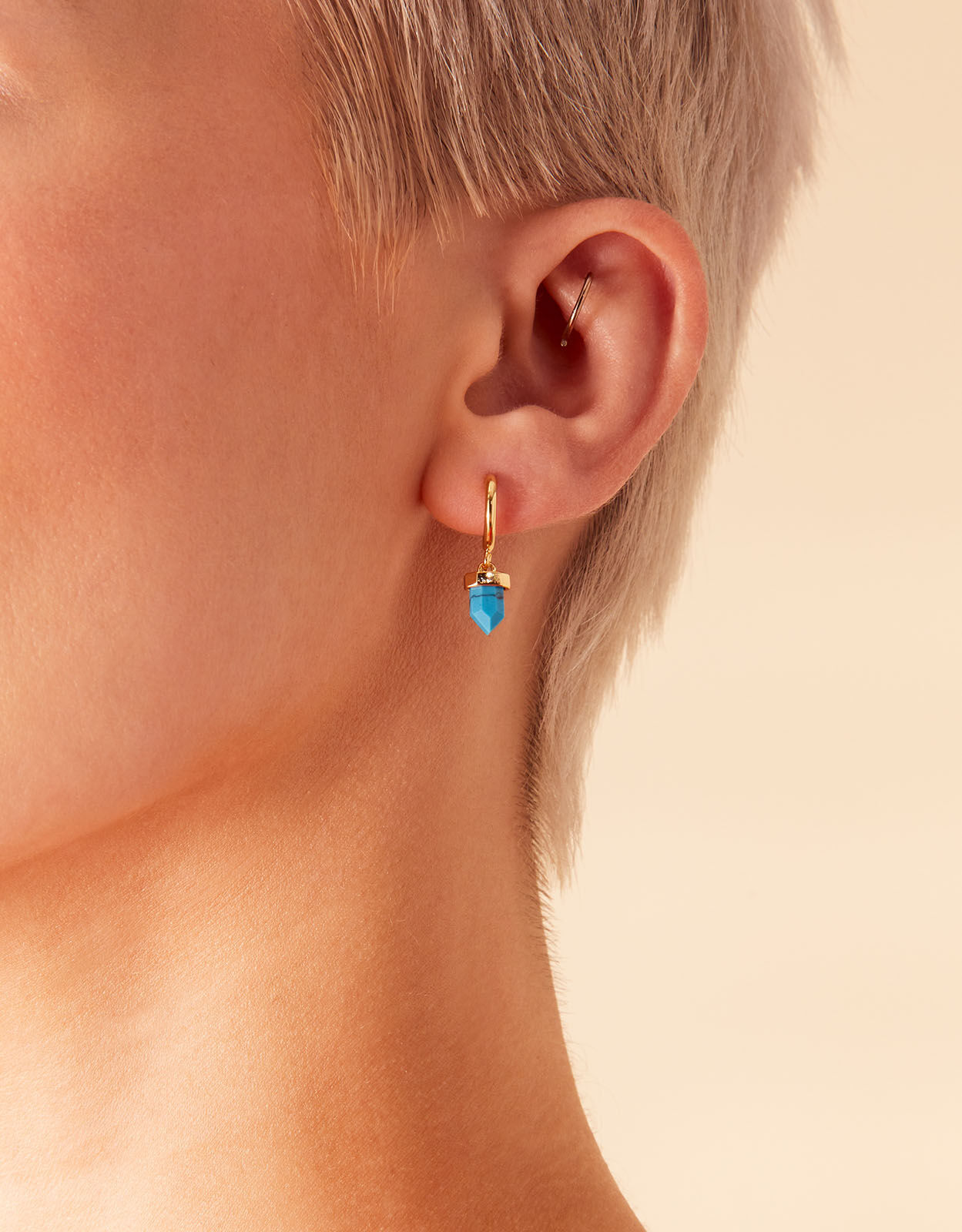Turquoise earrings accessorize top