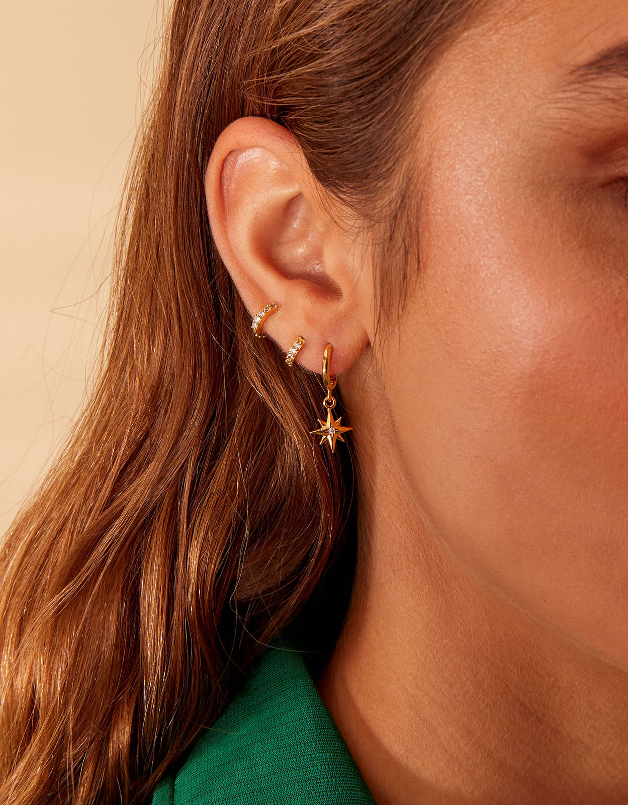 Gold hoop earrings top with star charm