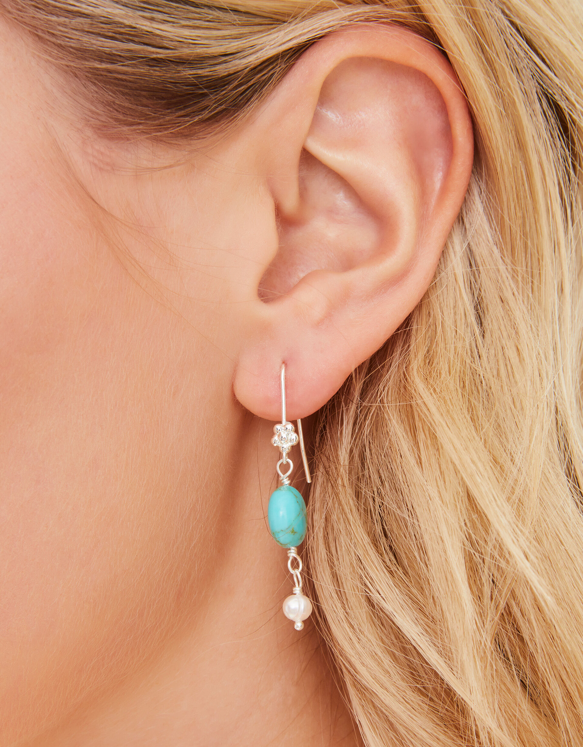 Turquoise earrings accessorize top